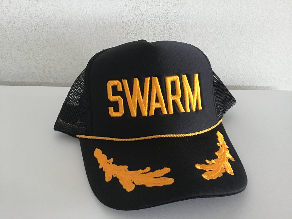 black trucker foam front hat with gold SWARM across the front embroidered a gold matching braid at the start of the bill and gold oak leaves on the bill