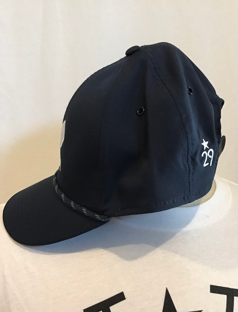 A navy baseball hat side view with the 29th state apparel logo in white on the back left panel