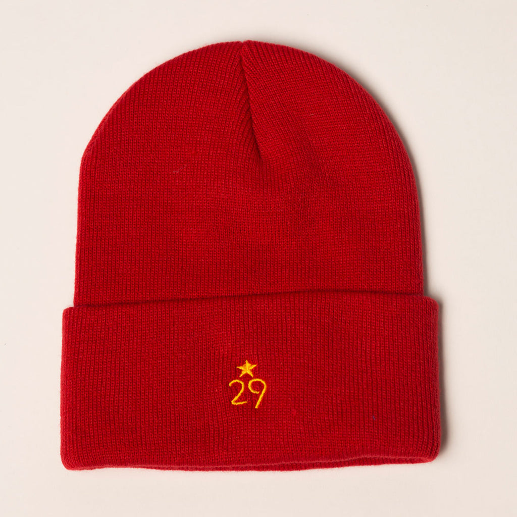 red beanie with folding cuff logo in gold centered on back