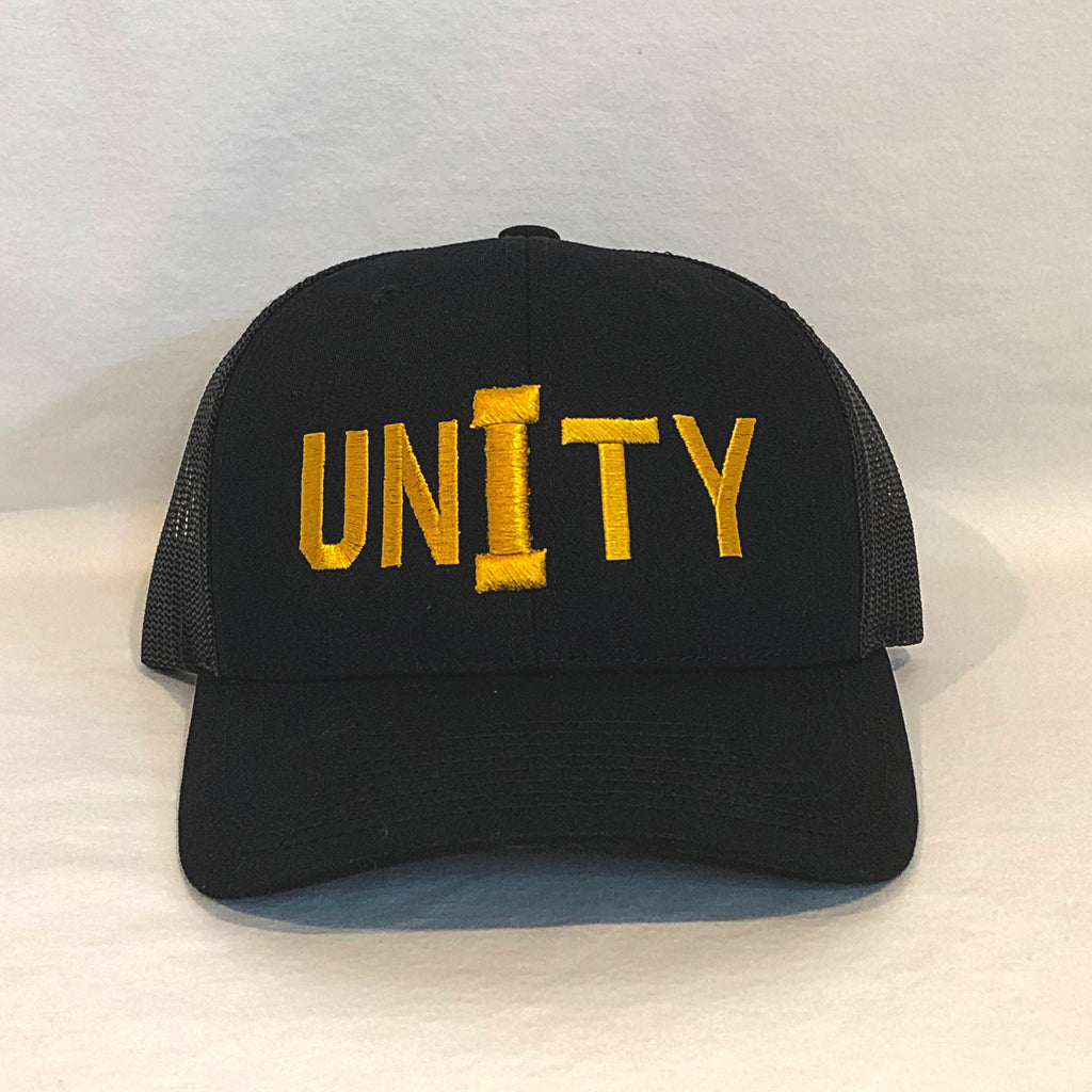unity in gold on an all black trucker hat