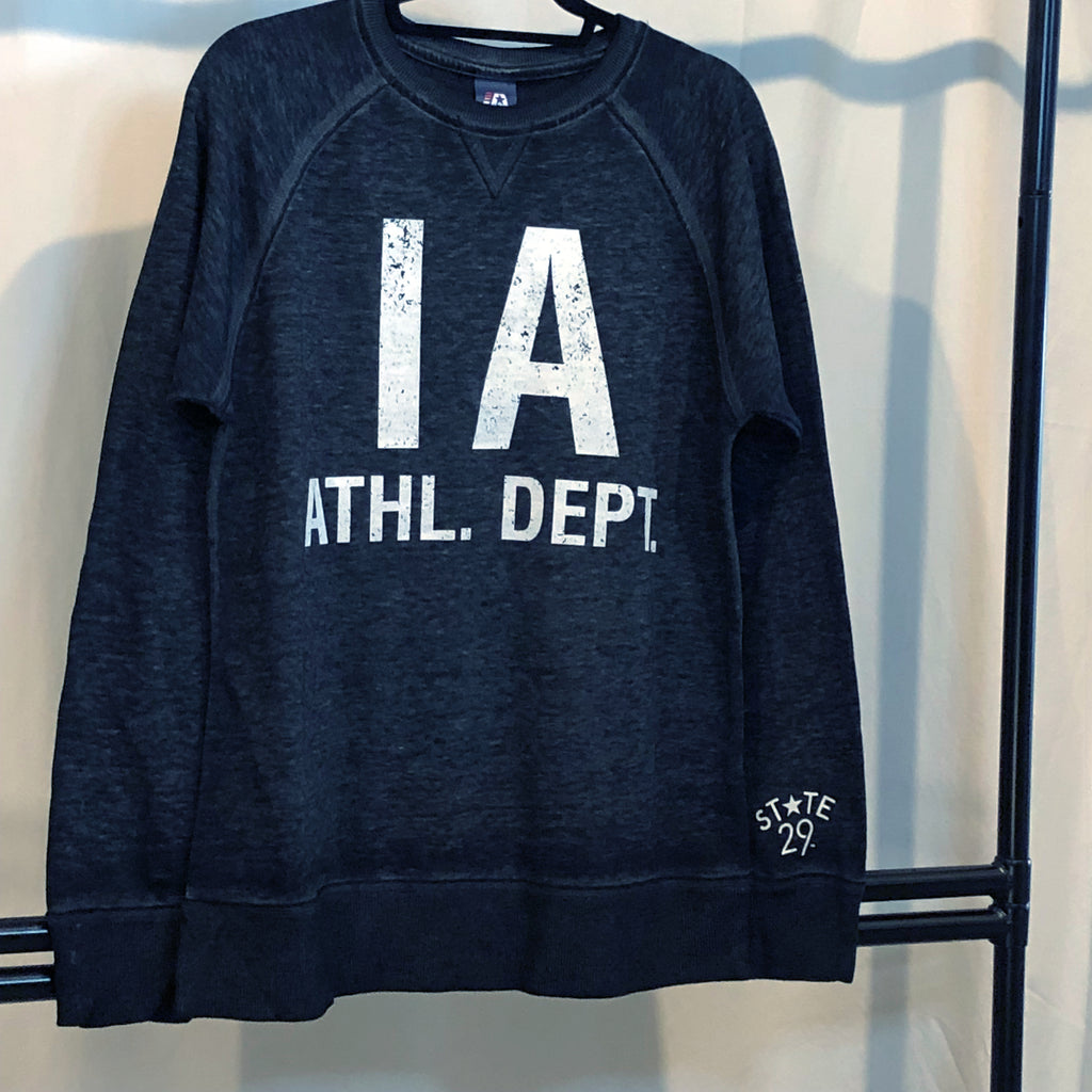A distressed vintage black crewneck sweatshirt that looks and feels like a sweater hanging from a rack featuring bold white type "IA ATHL. DEPT."