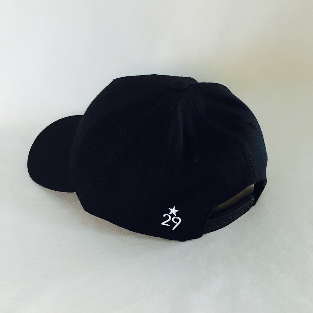 all black wool blend snapback adjustable hat looking at the back left side with the 29th state apparel logo