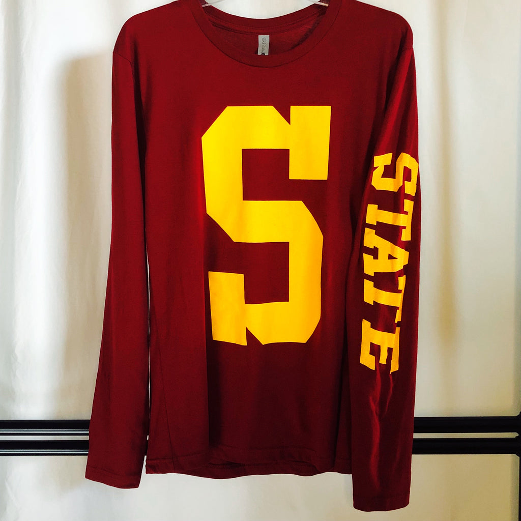 a red long sleeve shirt hanging from a hanger showcasing the big and bold "s" screenprinted on the front center and "State" in gold screenprint down the left sleeve