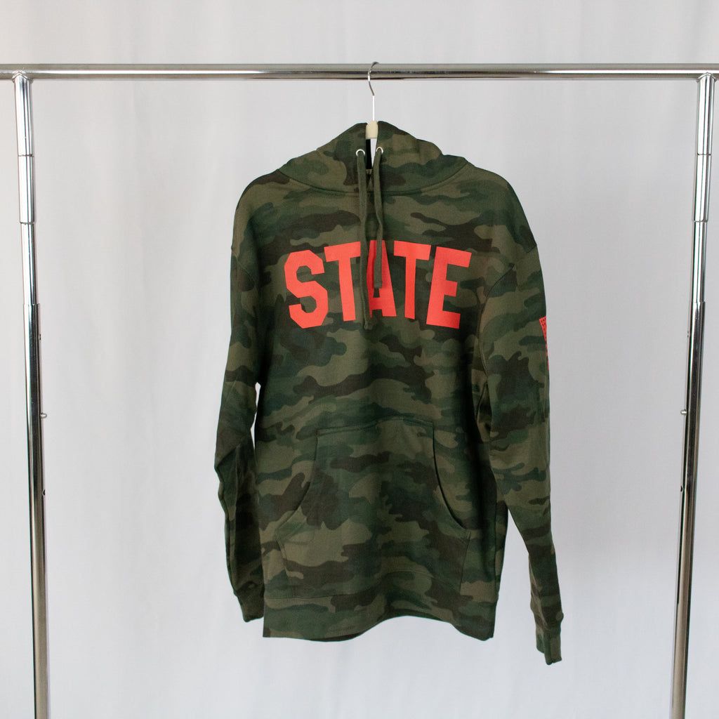 a hanging military green camo print hooded sweatshirt with state in red printed on front
