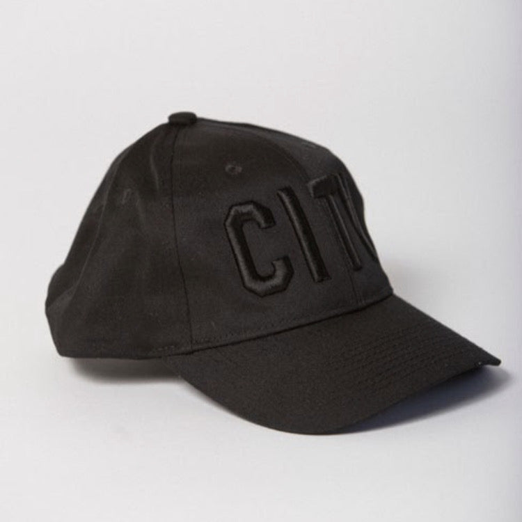 side view of black baseball hat with black CITY embroidered on the front