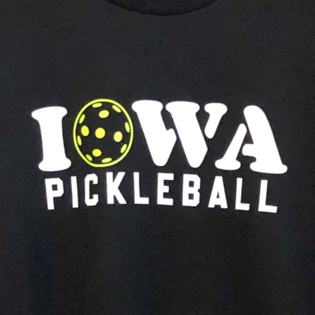 a closeup photo of the screen printed lettering "IOWA PICKLEBALL" the "O" of Iowa is a pickleball