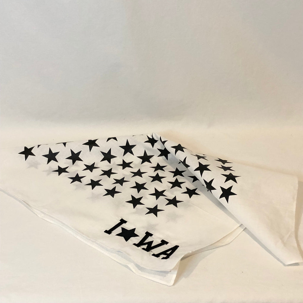 a white bandana with black stars all over and IOWA embroidered in the corner in black