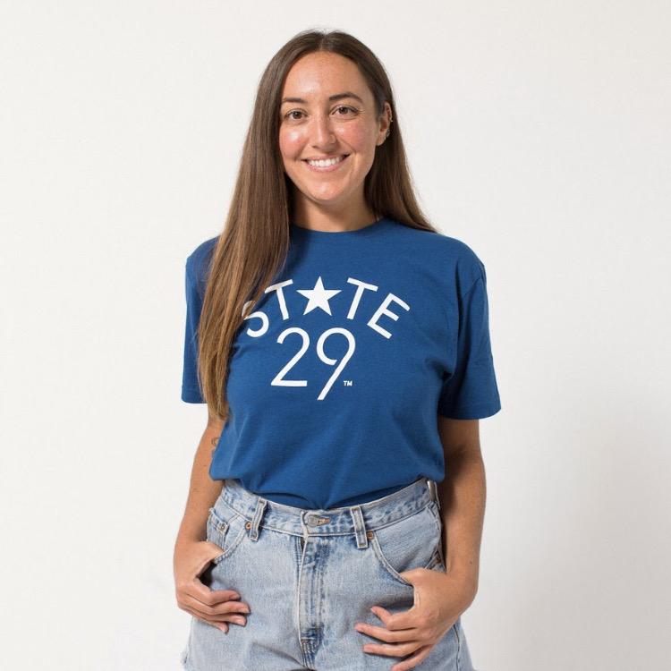 bronde model wearing a cool blue tee with 29th state apparel logo on front center